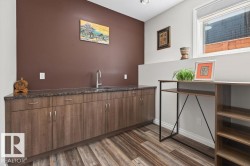 Extensive built-in cabinetry with a dark speckled countertop and undermount sink - 