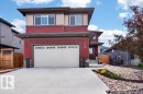Contemporary two-story residence featuring a red and beige exterior with stone accents - 71 Ratelle Circle, St. Albert, AB 