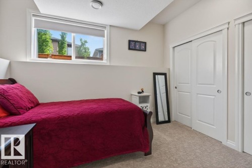 Room featuring light-colored walls, patterned carpeting, and a window with a roller shade - 71 Ratelle Circle, St. Albert, AB 