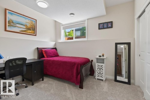 Carpeted room featuring a single window, white walls, and a built-in closet with sliding doors - 71 Ratelle Circle, St. Albert, AB 