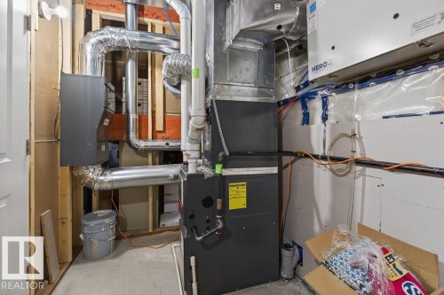 Utility area featuring a furnace system with associated ductwork and piping - 71 Ratelle Circle, St. Albert, AB 