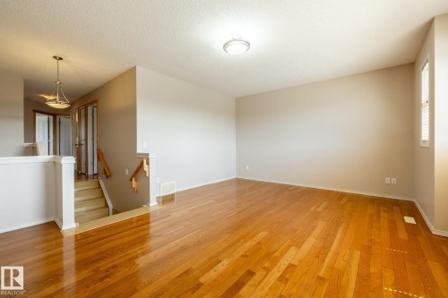 Hardwood flooring throughout the main living space - 55 Lamplight Cove, Spruce Grove, AB - Indoor Photo Showing Other Room