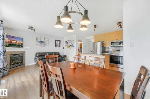 Open-concept living area with wood-finish flooring - 2921 23 Street, Edmonton, AB 