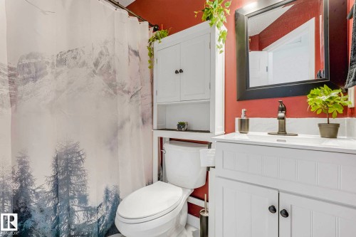 White vanity with integrated sink and dark bronze faucet - 2921 23 Street, Edmonton, AB 