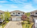 Two-story residential building featuring light-colored siding and a multi-pitch roof - 2921 23 Street, Edmonton, AB 