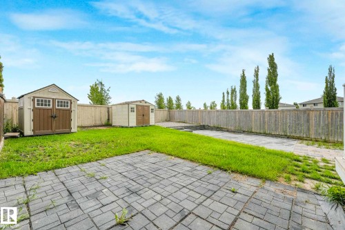 Expansive backyard featuring a combination of paver patio and lawn areas - 2921 23 Street, Edmonton, AB 