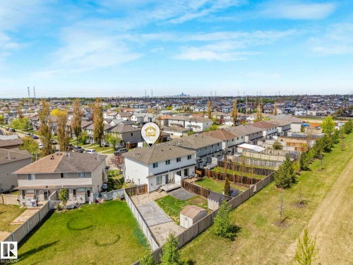 Rear property exterior featuring a fenced yard with a storage shed and a concrete patio - 2921 23 Street, Edmonton, AB 