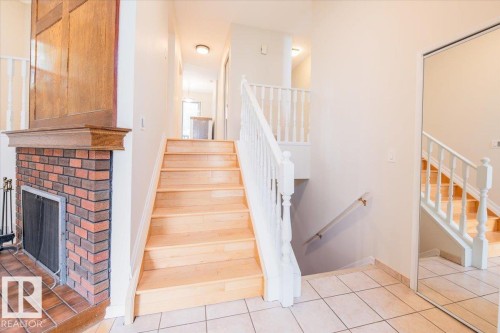 Staircase featuring wood-finish treads and white balusters - 4107 147 Street, Edmonton, AB 