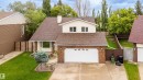 Traditional-style residence featuring a brick facade, light-toned siding, and a brown shingle roof - 4107 147 Street, Edmonton, AB 
