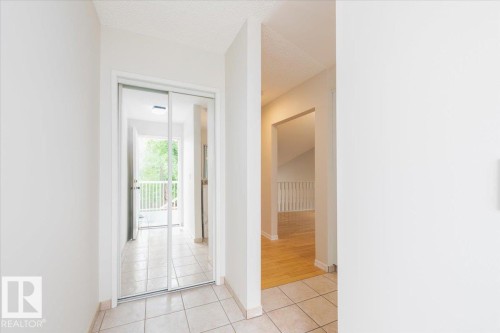 Entryway with tile flooring, mirrored closet doors, and recessed lighting - 4107 147 Street, Edmonton, AB 
