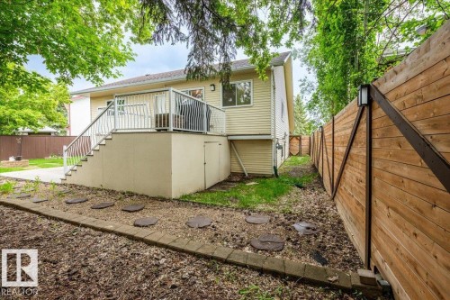 Rear exterior featuring a raised deck with white metal railings - 4107 147 Street, Edmonton, AB 