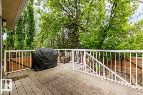 Expansive outdoor deck featuring wood decking and white railings - 4107 147 Street, Edmonton, AB 