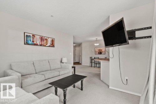 Expansive living area featuring light-colored carpeting and neutral wall tones - 232 4309 33 Street, Stony Plain, AB 