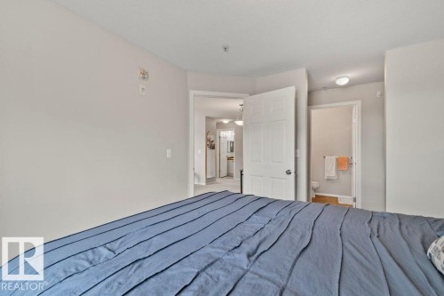 Neutral-toned interior featuring an entry to an additional space and an en-suite bathroom - 232 4309 33 Street, Stony Plain, AB 