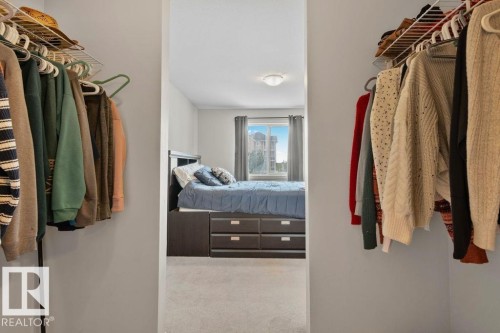Walk-in closet featuring built-in wire shelving and hanging rods - 232 4309 33 Street, Stony Plain, AB 