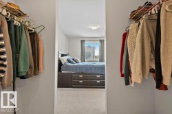Walk-in closet featuring built-in wire shelving and hanging rods - 