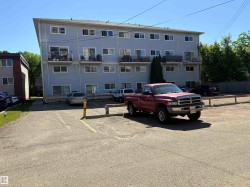 parking beside the red truck and yellow post - 