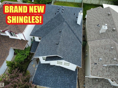 Newly installed dark gray architectural shingle roof with multiple gables - 21113 92A Avenue Nw, Edmonton, AB 