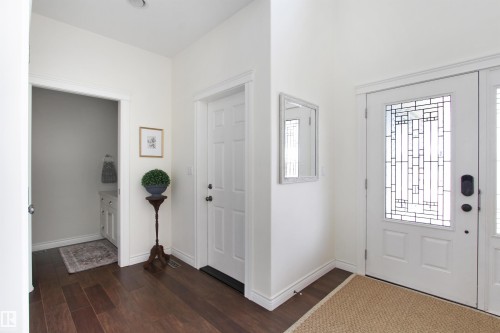 Front entry featuring a decorative glass panel door and wood-finish flooring - 34 Falcon Road, Cold Lake, AB 
