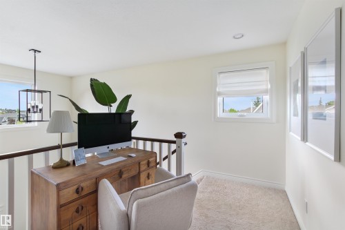 Loft area featuring a window with a Roman shade, light-colored carpeting, recessed lighting, and a contemporary chandelier - 34 Falcon Road, Cold Lake, AB 