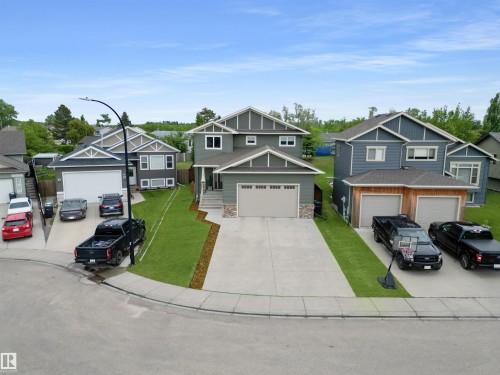 Contemporary two-story residence with a multi-gabled roofline and a neutral siding exterior - 34 Falcon Road, Cold Lake, AB 