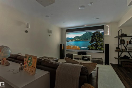 Dedicated media space featuring a large projection screen and integrated ceiling speakers - 34 Falcon Road, Cold Lake, AB 