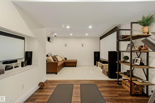 Recreation room featuring wood-finish flooring, recessed lighting, and a built-in projection screen - 34 Falcon Road, Cold Lake, AB 