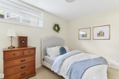 Bedroom featuring soft cream-colored walls and light-colored carpeting - 34 Falcon Road, Cold Lake, AB 