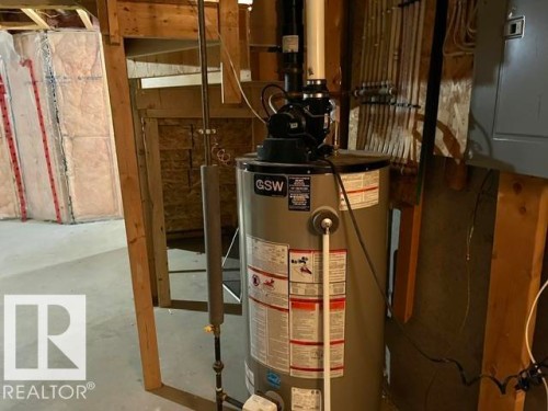 GSW water heater unit with associated piping, electrical conduit, and exposed wood framing - 1 5281 Terwillegar Boulevard, Edmonton, AB 