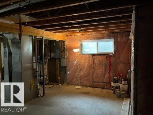 Unfinished basement space with exposed ceiling joists and concrete flooring - 1 5281 Terwillegar Boulevard, Edmonton, AB 