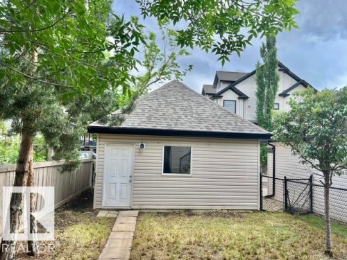 Detached accessory structure with siding exterior and shingled roof - 1 5281 Terwillegar Boulevard, Edmonton, AB 