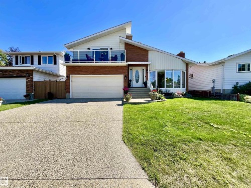 Split-level home featuring brick and vertical siding accents - 11031 166 Avenue, Edmonton, AB 