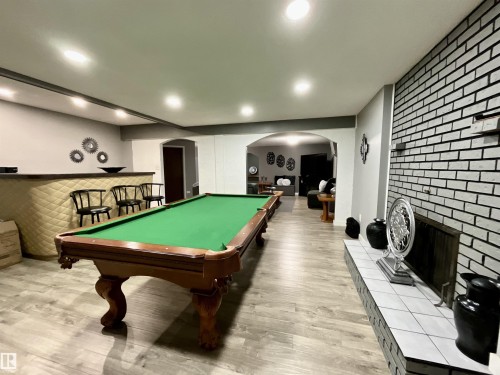 Entertainment space featuring wood-finish flooring, recessed lighting, and an arched doorway - 11031 166 Avenue, Edmonton, AB 