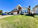 Brick and siding exterior with a prominent curved bay window - 11031 166 Avenue, Edmonton, AB 
