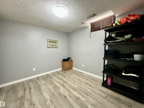 Interior room featuring light wood-finish flooring and grey wall finishes - 11031 166 Avenue, Edmonton, AB 
