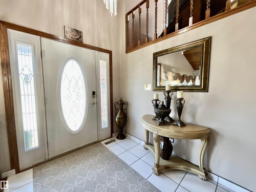 Entryway featuring a white door with an oval decorative glass insert, flanked by two sidelights with decorative glass - 11031 166 Avenue, Edmonton, AB 