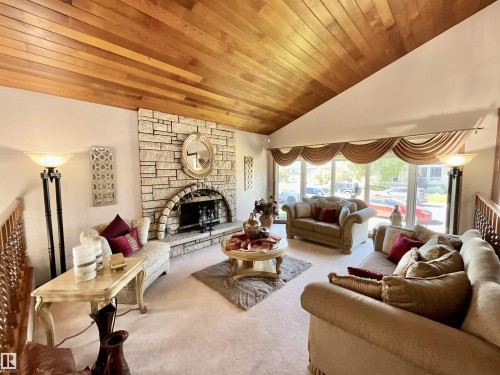 Vaulted wood-finish ceiling above a stone fireplace with an arched firebox - 11031 166 Avenue, Edmonton, AB 