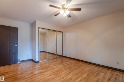 Hardwood-finish flooring throughout, complemented by a ceiling fan with integrated lighting - 