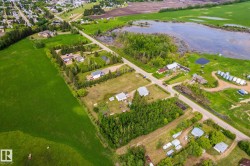 Aerial perspective showcasing expansive green fields and scattered residential properties - 