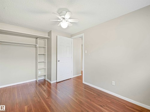 Room featuring wood-finish flooring, light gray wall paint, and white trim - 13114 30 Street, Edmonton, AB - Indoor Photo Showing Other Room