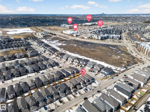 Aerial view of a residential community featuring detached homes with dark roofs and light-colored siding - 1684 12 Street, Edmonton, AB 