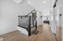 Staircase with dark balusters and carpeted treads - 1684 12 Street, Edmonton, AB 