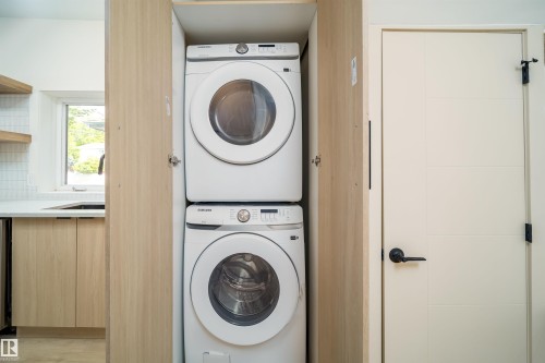 Integrated stacked laundry machines within a wood-finish cabinet - 10866 92 Street, Edmonton, AB 