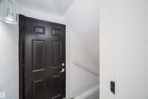 Black six-panel door with silver-tone hardware - 10866 92 Street, Edmonton, AB 