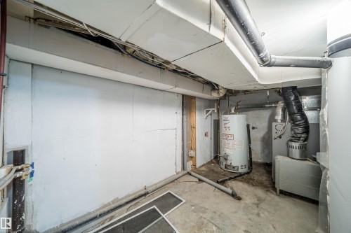 Utility area with exposed ceiling beams and concrete flooring - 10866 92 Street, Edmonton, AB 