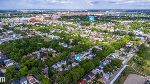 Aerial perspective showcasing an expansive residential area with dense tree coverage - 10866 92 Street, Edmonton, AB 