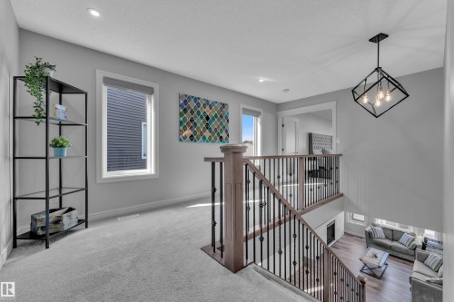 Upper-level landing featuring light gray carpeting and recessed lighting - 17551 64 Street, Edmonton, AB 