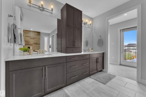 Contemporary bathroom featuring a double vanity with dark wood cabinetry and a white countertop - 17551 64 Street, Edmonton, AB 