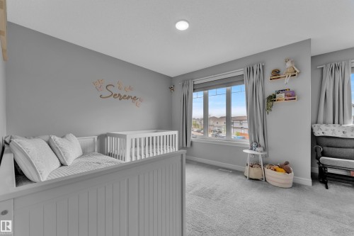 Spacious room with light gray walls, plush gray carpeting, and multiple windows with gray drapes - 17551 64 Street, Edmonton, AB 