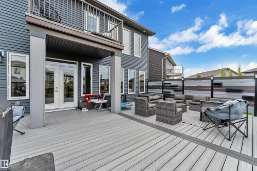 Expansive multi-level composite deck with integrated accent lighting and privacy fencing - 17551 64 Street, Edmonton, AB 